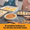 Bakeware with bread rolls, pie and cookies