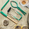 Canning tools beside jars and lids